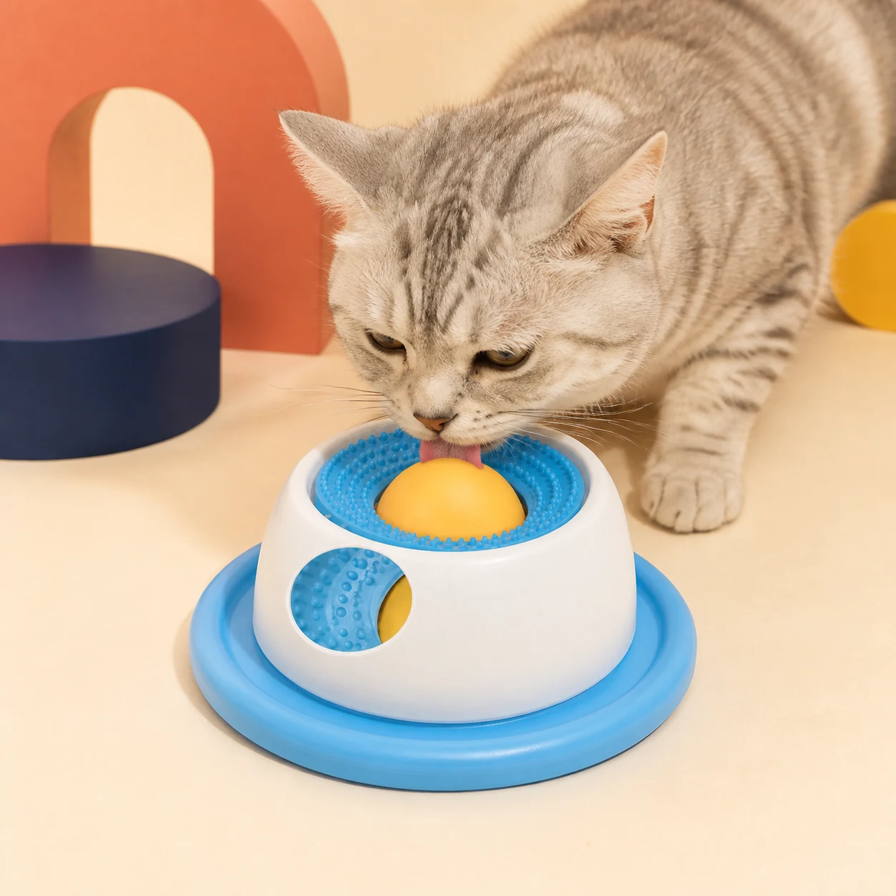 Cat investigating a blue PETEE interactive puzzle feeder